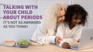 Mother talking with her child, looking at a computer. Text overlay reads "Talking with your child about periods. It's not as awkward as you think!"
